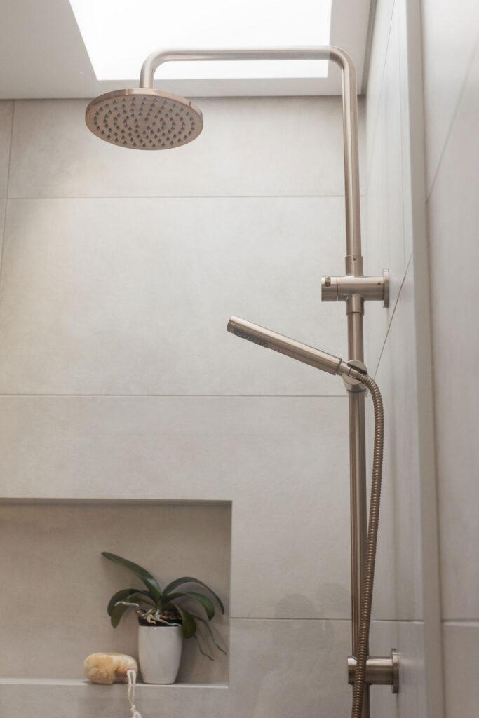 Warm stone look tiles with two in one shower