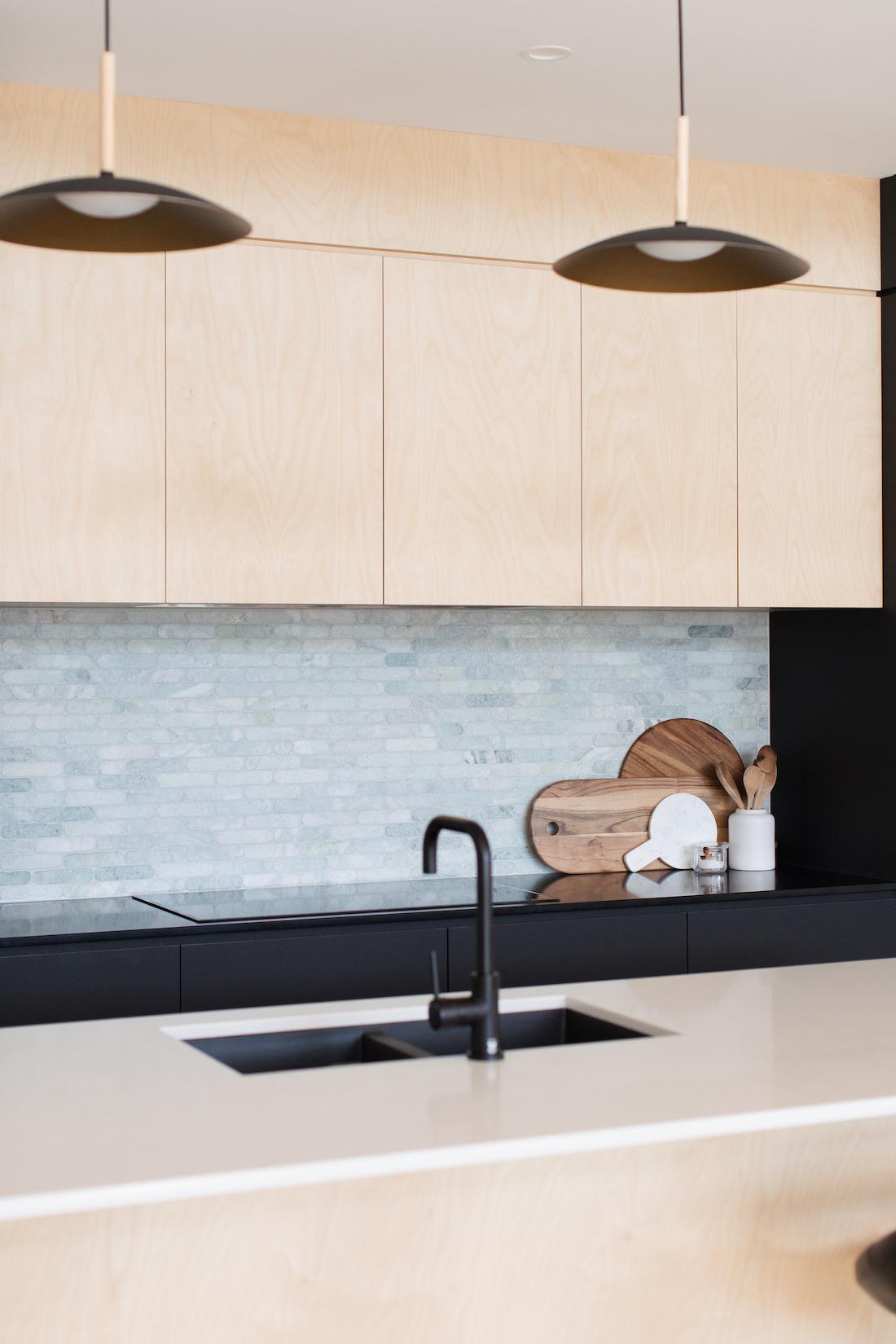 Ply kitchen with pale green marble splashback