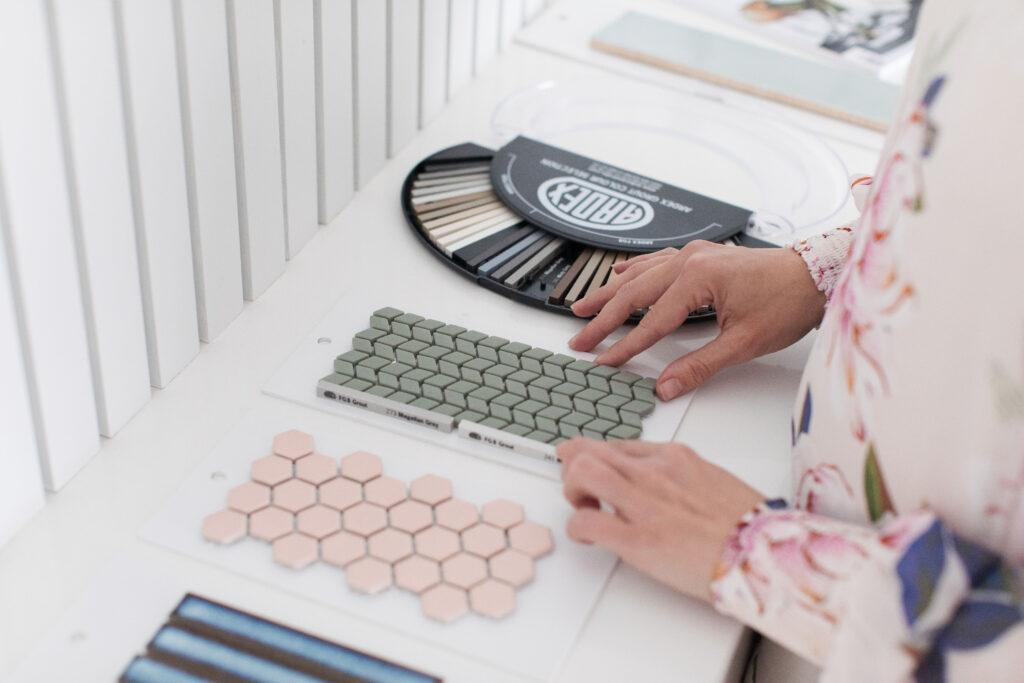 lady picking grout color for tiles