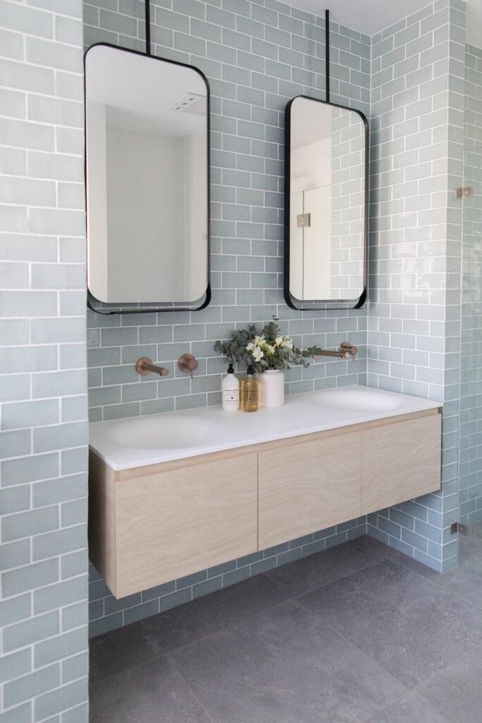 Blue subway tile bathroom Double bowl vanity with two single mirrors