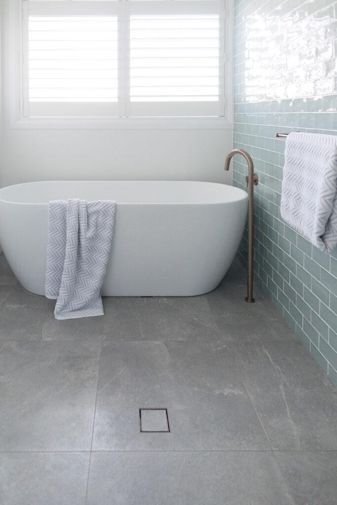 Blue subway tile bathroom Italian grey floor tile