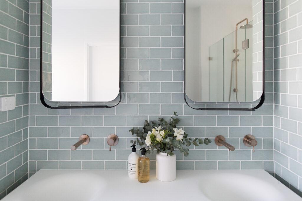 Blue subway tile bathroom Double black frame mirrors