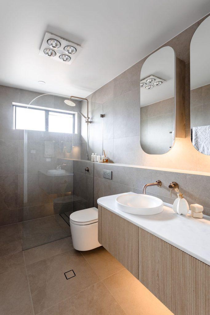 Half height bathroom wall connects the space beautifully